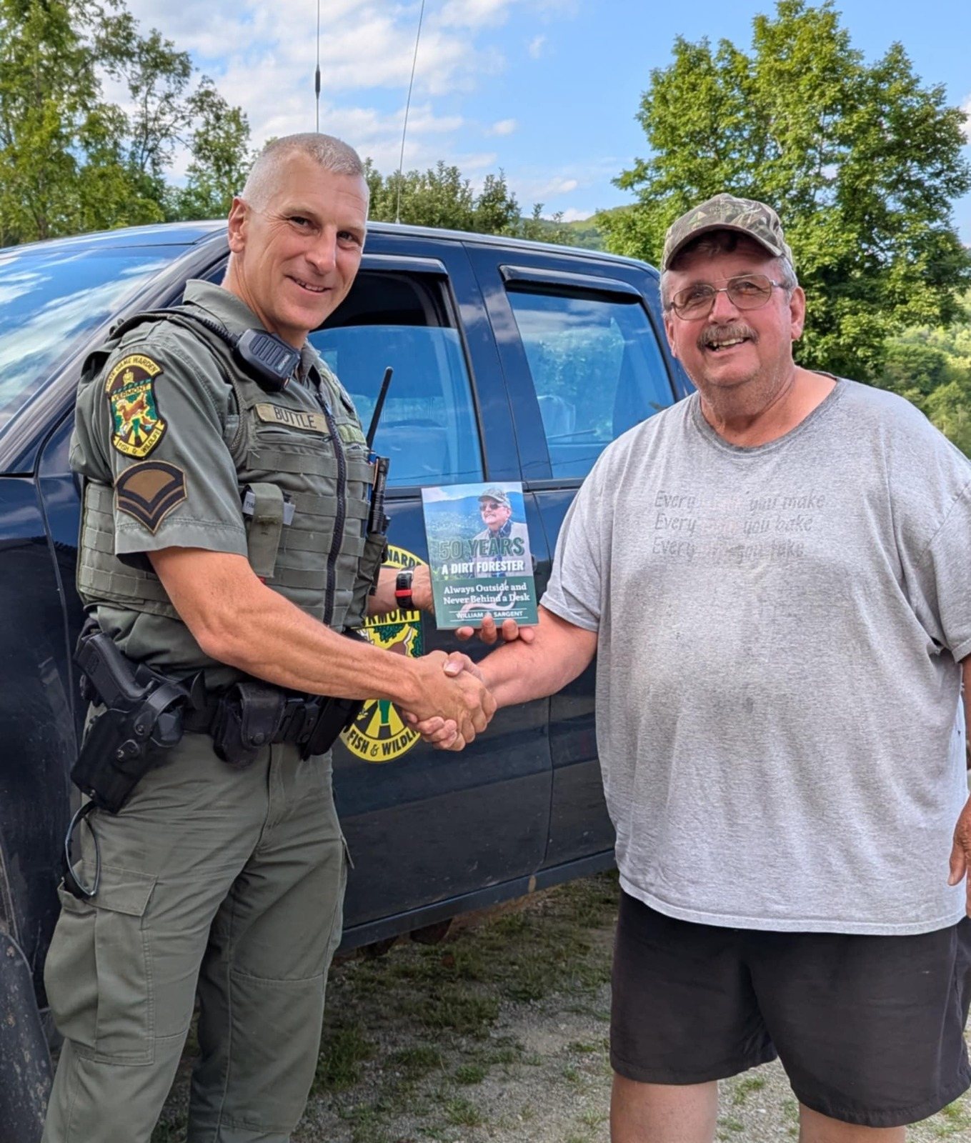 William Sargent shaking hands with a Vermont game warden